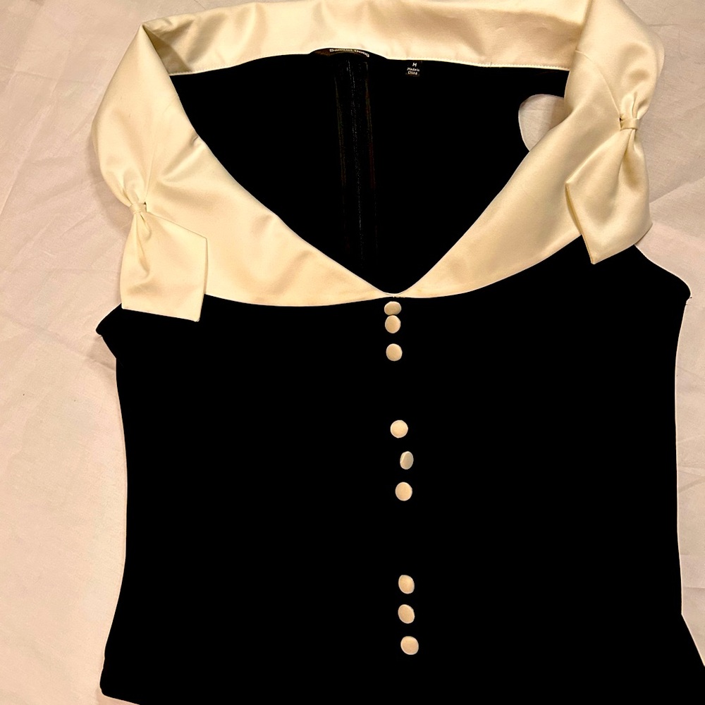 A black shirt with a white collar